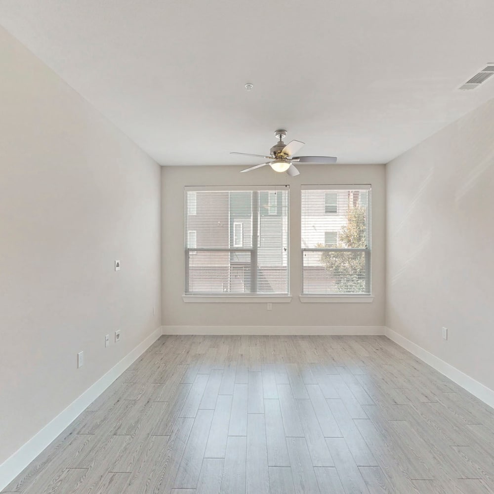 Bay windows and a ceiling fan in a model home's living area at Oaks Trinity in Dallas, Texas