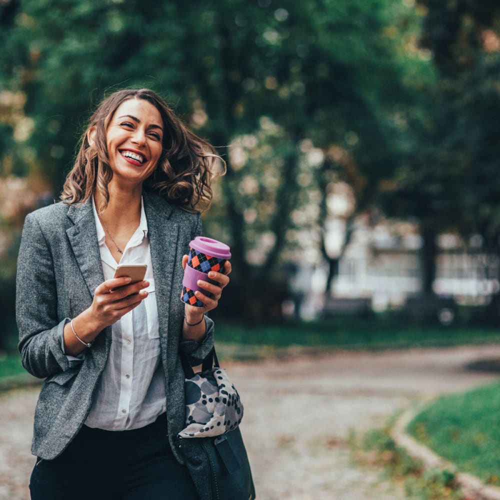 Resident walking to work with her coffee in hand near Oaks Union Depot in St Paul, Minnesota