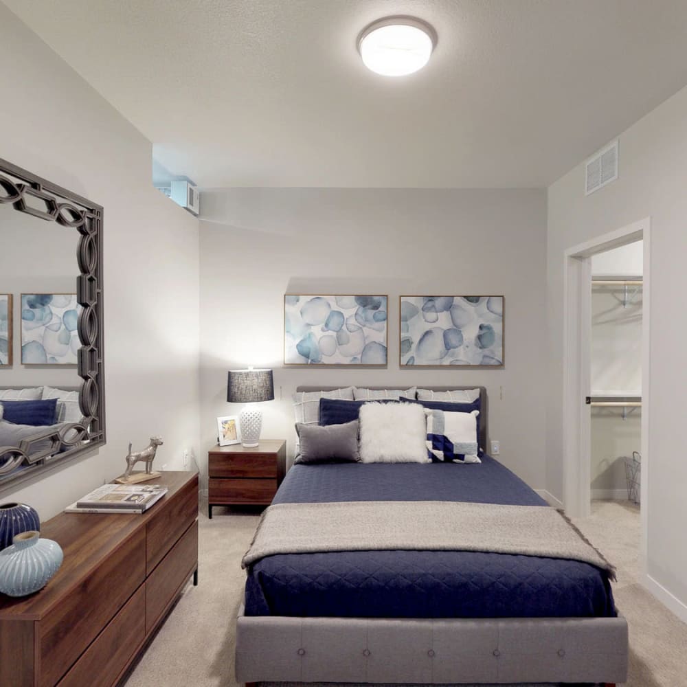 Well-furnished model home's primary bedroom with plush carpeting at Oaks Union Depot in St Paul, Minnesota