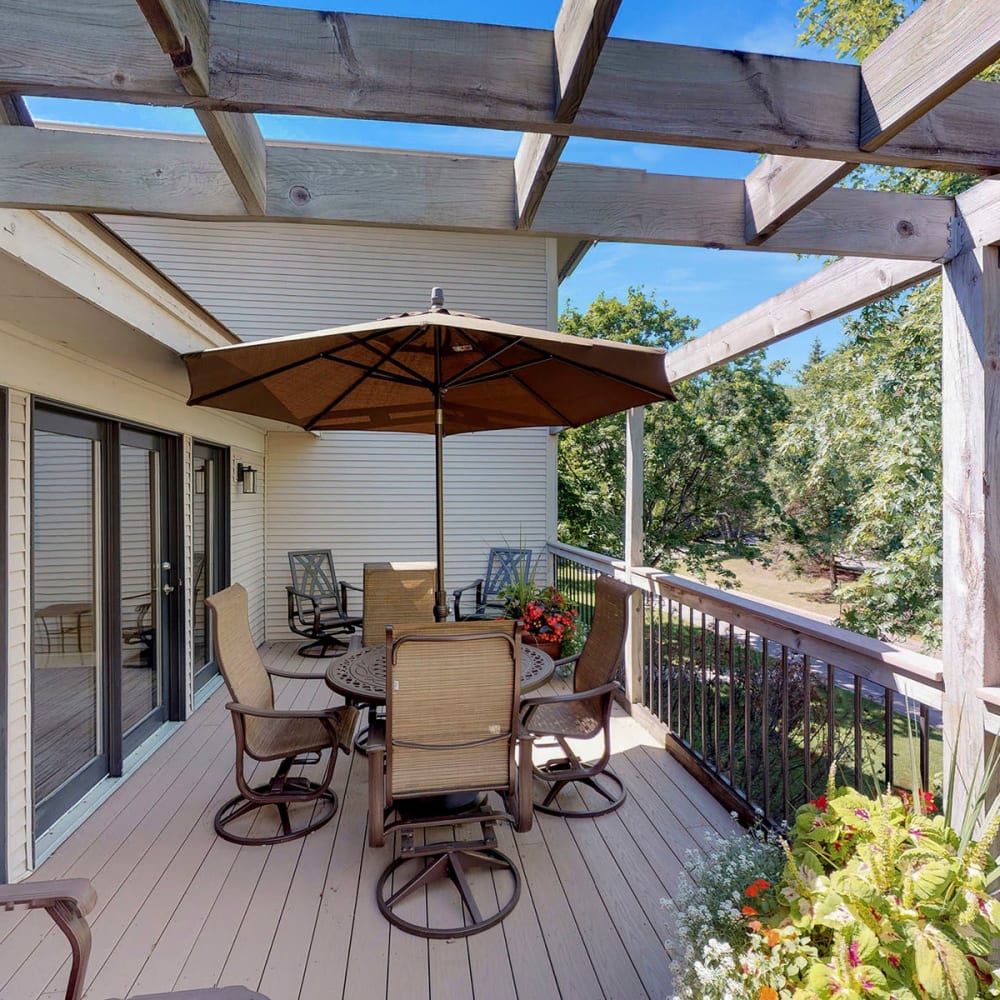 Shaded seating on the deck outside the resident clubhouse at Oaks Vernon in Edina, Minnesota