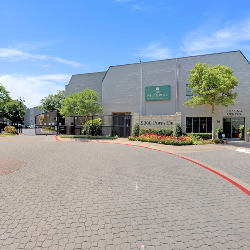 Cobblestone drive leading up to the leasing center at Oaks White Rock in Dallas, Texas
