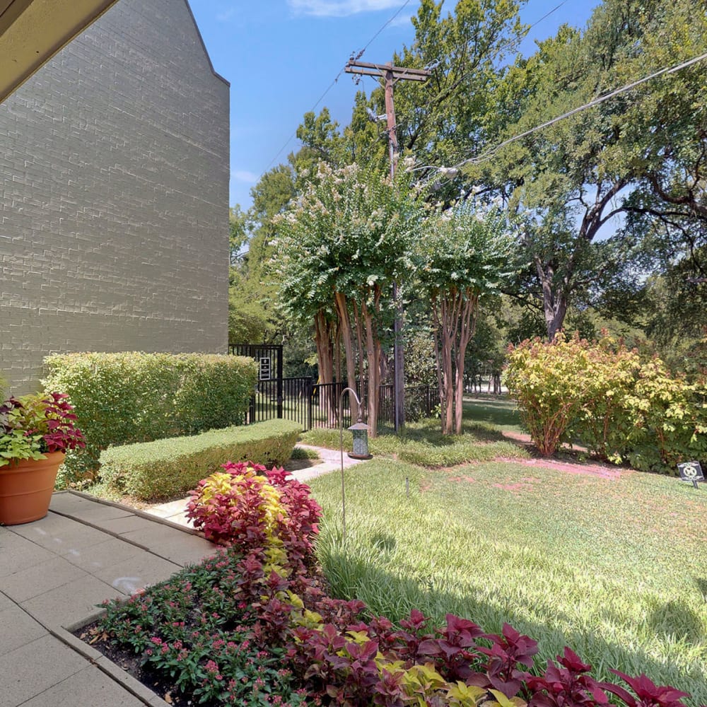 Professionally maintained landscaping throughout the community at Oaks White Rock in Dallas, Texas