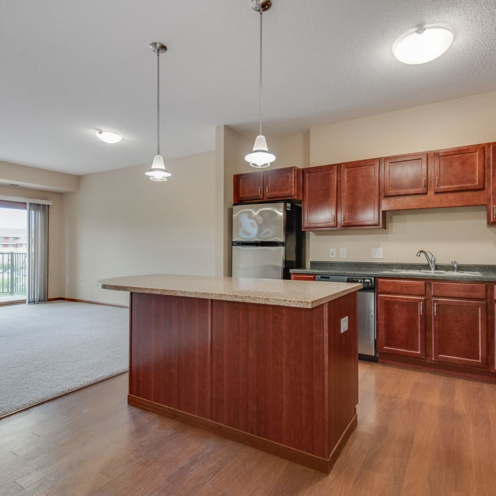 Apartment home's open-concept kitchen with stainless-steel appliances at Oaks Glen Lake in Minnetonka, Minnesota