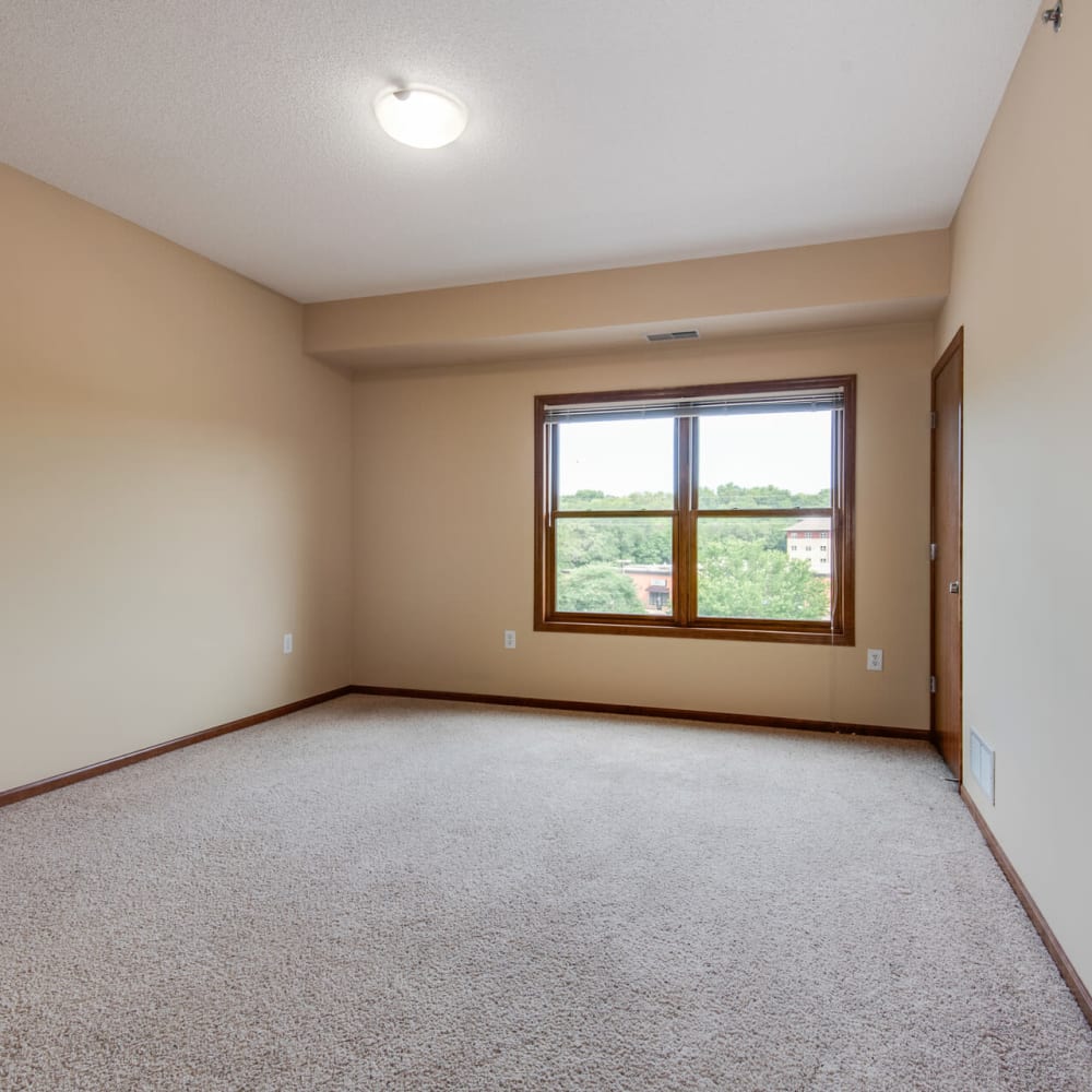 Bedroom with plush carpeting in a model home at Oaks Glen Lake in Minnetonka, Minnesota