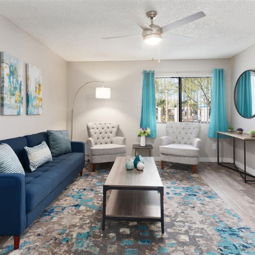 A spacious living room with a ceiling fan at 1408 Casitas at Palm Valley in Avondale, Arizona