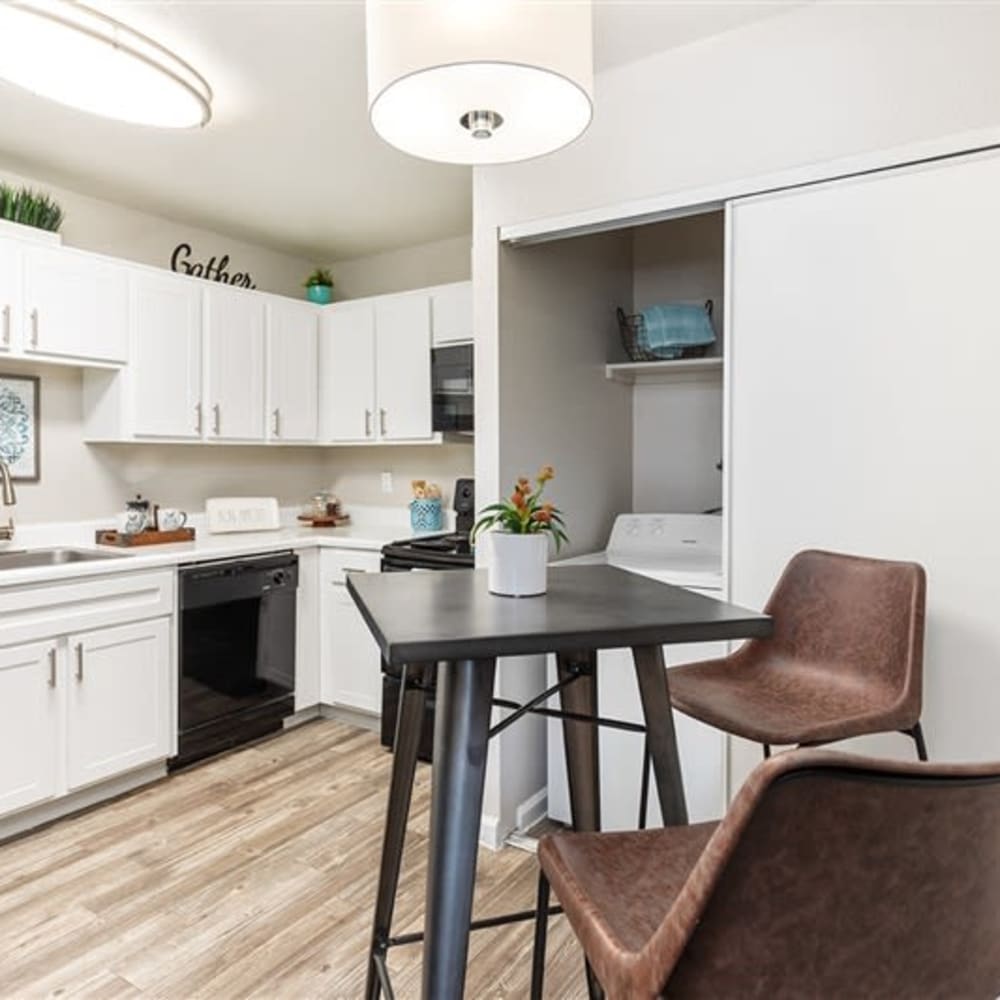 A kitchen with white cabinets at Argenta Apartments in Mesa, Arizona