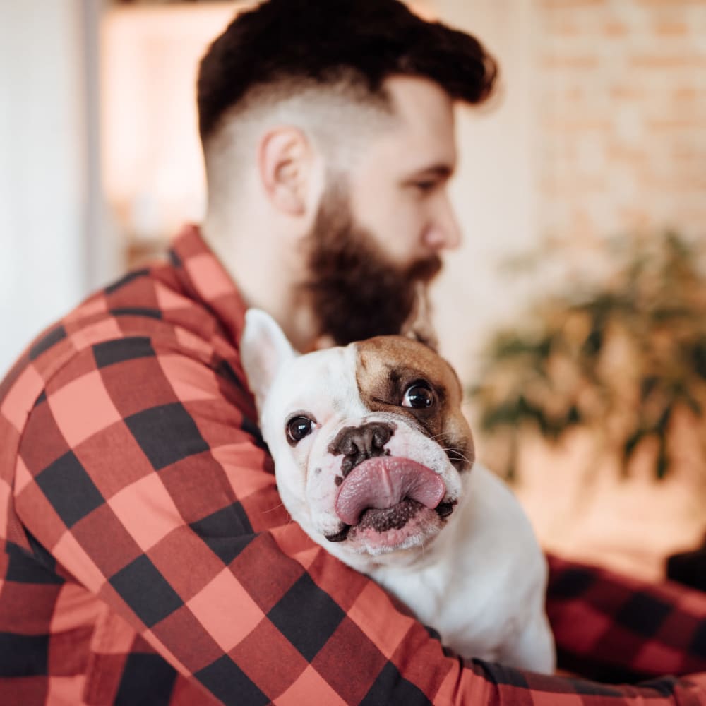 Resident hugging his dog at The Gallery Lofts in Winston Salem, North Carolina