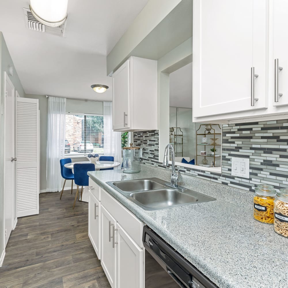 A large kitchen with white appliances at Barringer Square in Webster, Texas