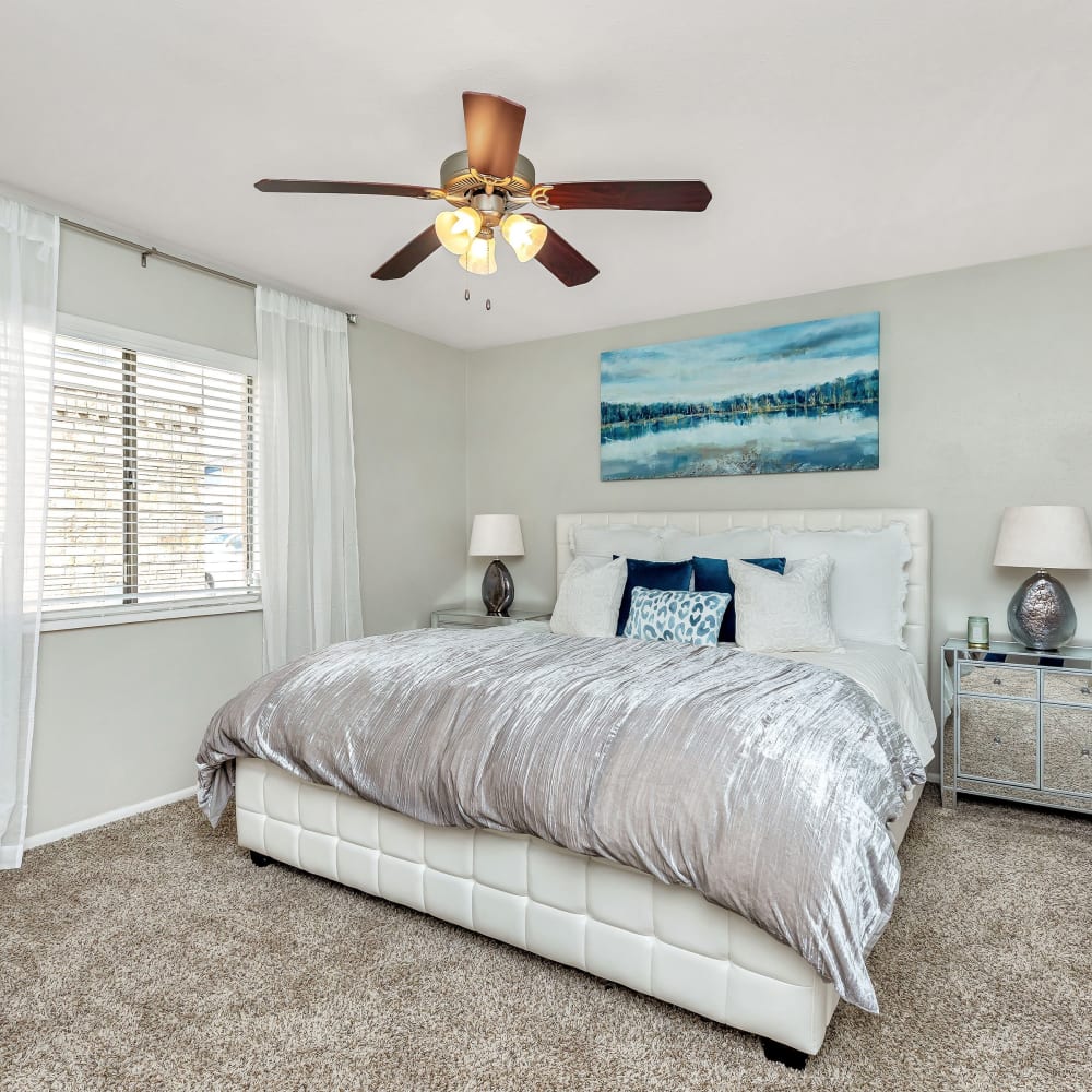 A spacious bedroom with plush carpeting at Barringer Square in Webster, Texas