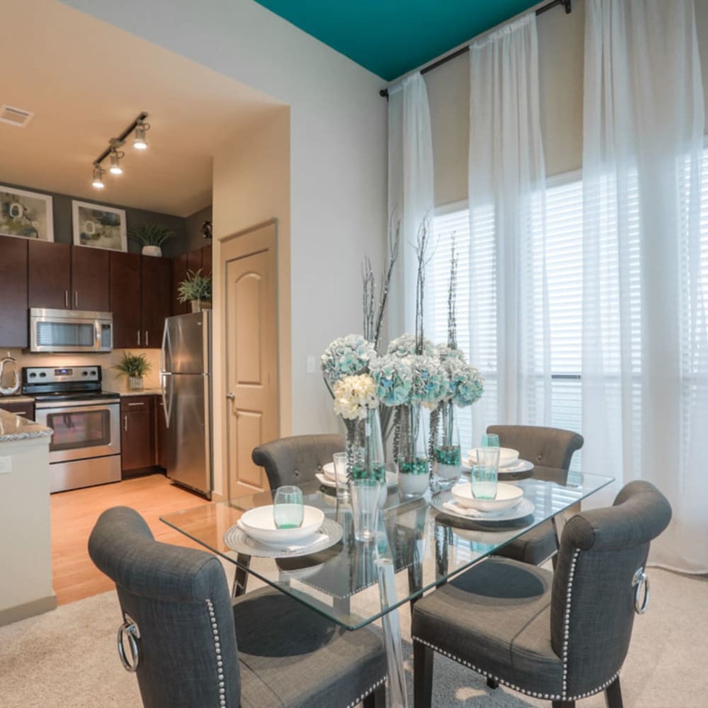 Dining area and gourmet kitchen of a model apartment home at Imperial Lofts in Sugar Land, Texas