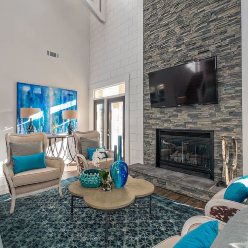 Community lounge with fireplace and TV at Butternut Ridge Apartments in North Olmsted, Ohio