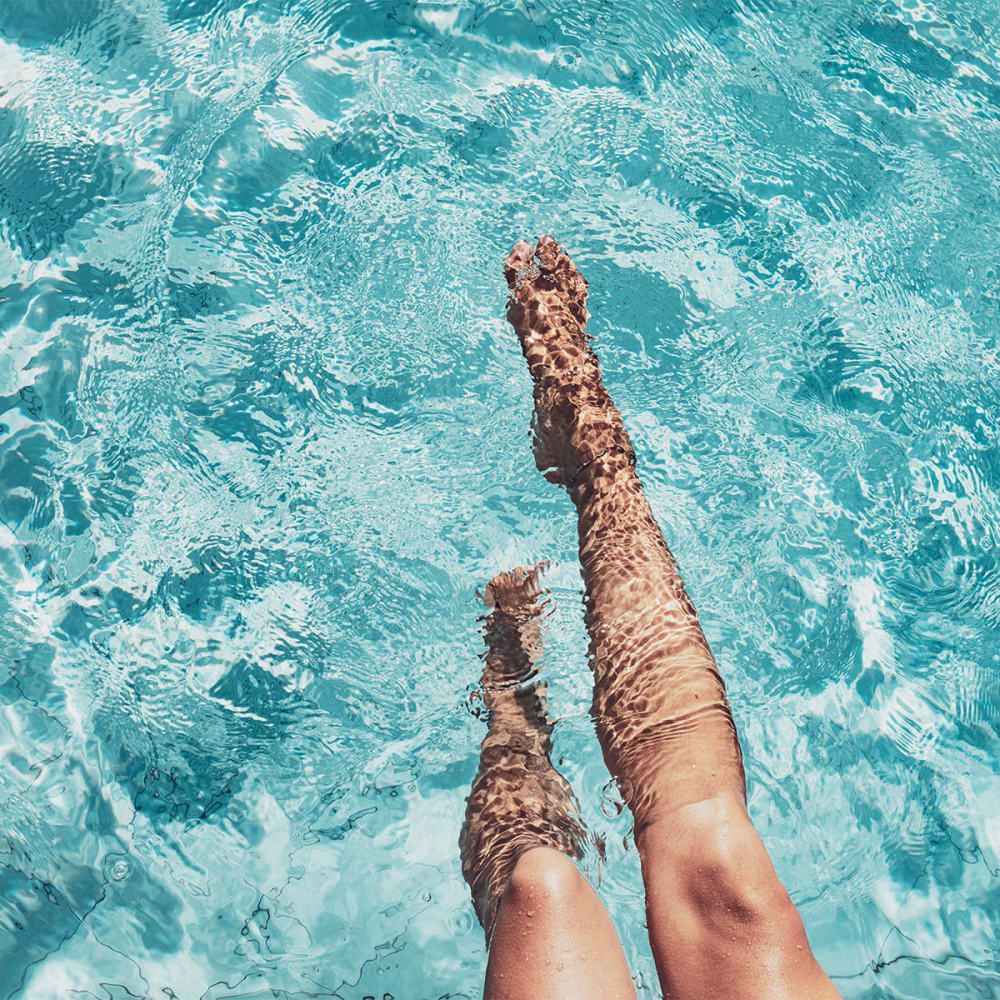 Resident cooling her legs in the swimming pool at Mission Rock at Novato in Novato, California