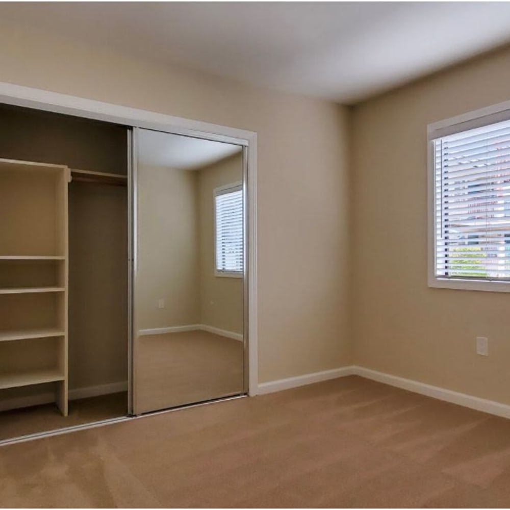 Plush carpeting and an en suite bathroom in a model apartment's primary bedroom at Mission Rock at Marin in San Rafael, California