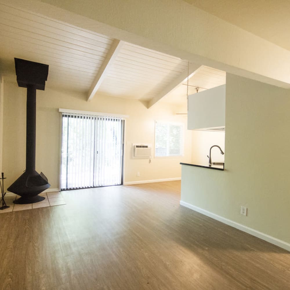 Living Room with vaulted ceilings and a wood burning fireplace in a model home at Mission Rock at North Bay in Novato, California