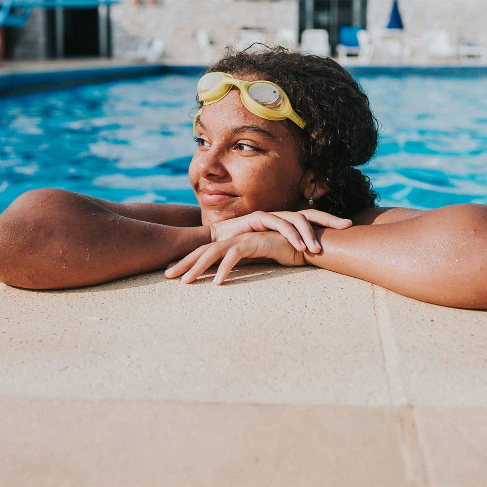 Resident relaxing at pool's edge after swimming some laps at Mission Rock at San Rafael in San Rafael, California