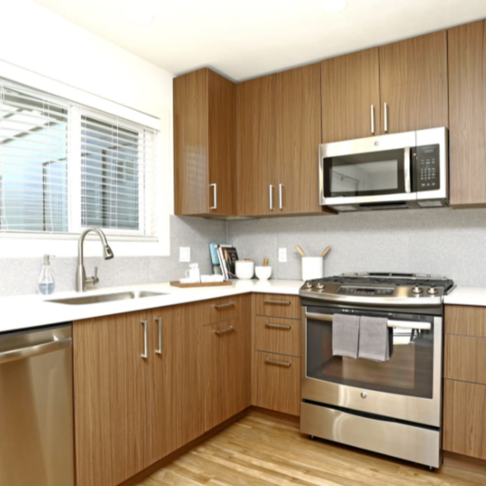 Model apartment's kitchen with stainless-steel appliances and quartz countertops at our Parc Marin community at Mission Rock at San Rafael in San Rafael, California