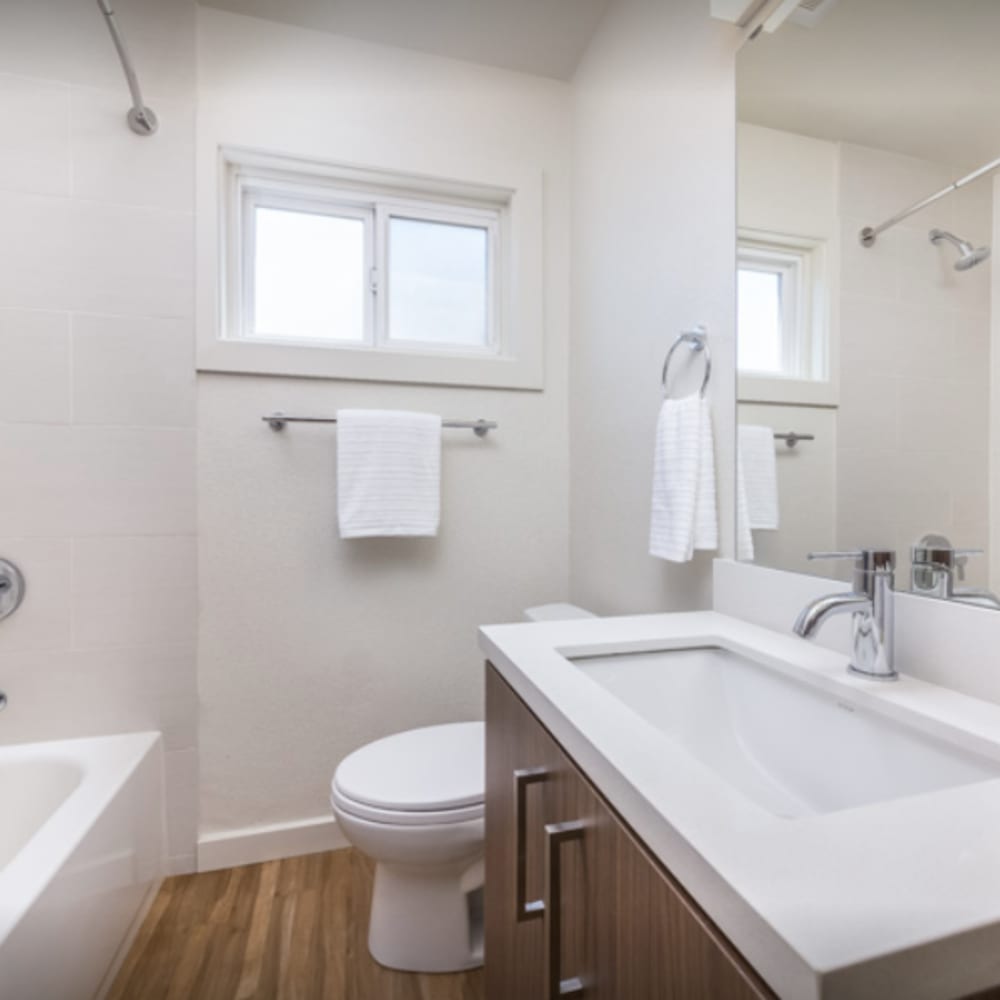 Model apartment's bathroom with a quartz countertop and wood-style flooring at our Parc Marin community at Mission Rock at San Rafael in San Rafael, California