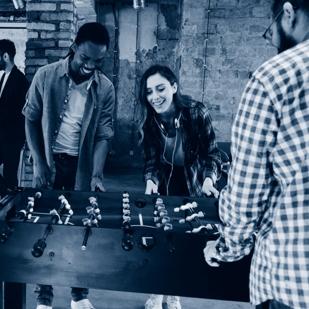 Residents playing foosball at The Carlyle Apartments in Baltimore, Maryland