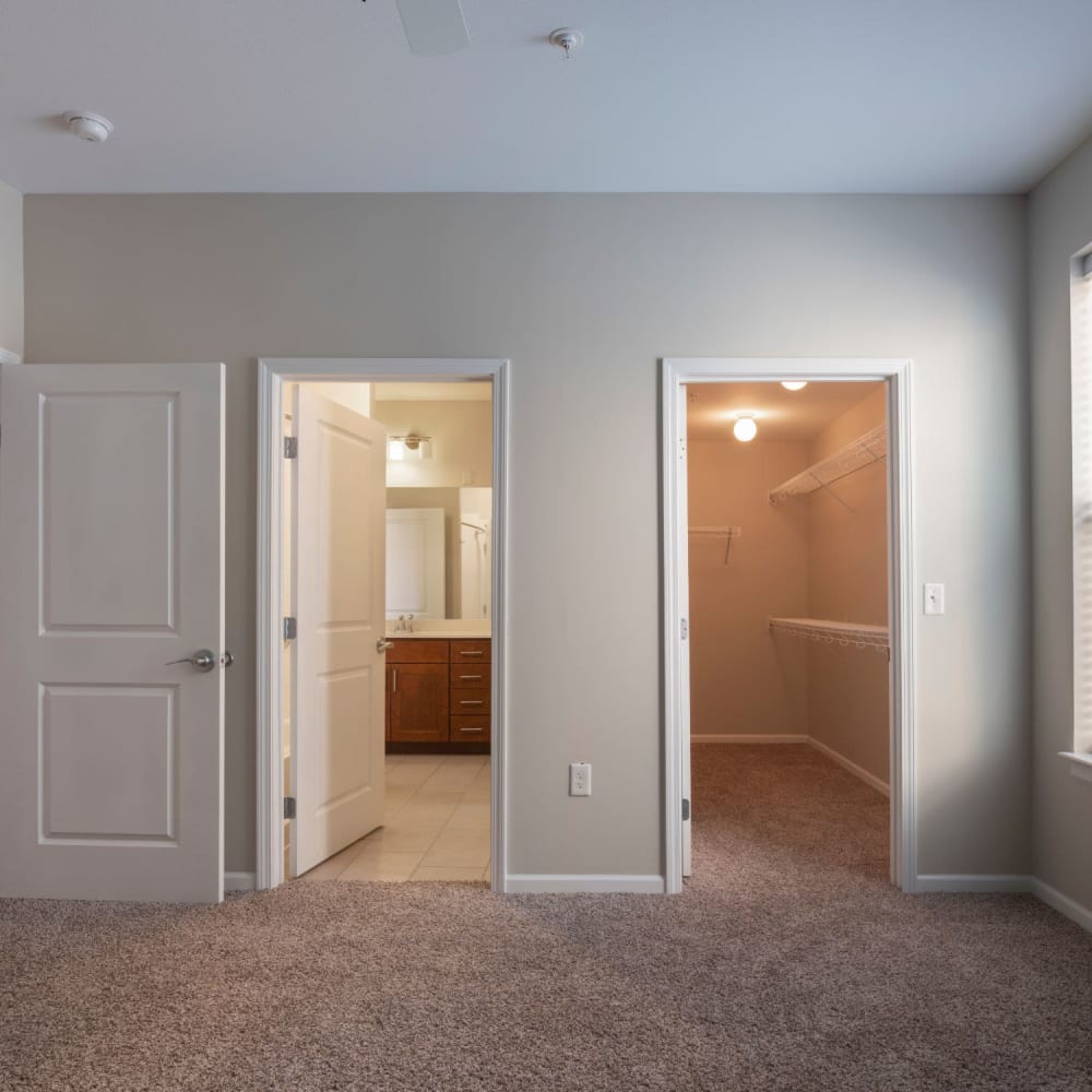 Bedroom with a walk-in closet and bathroom at Oaks Centropolis Apartments in Kansas City, Missouri