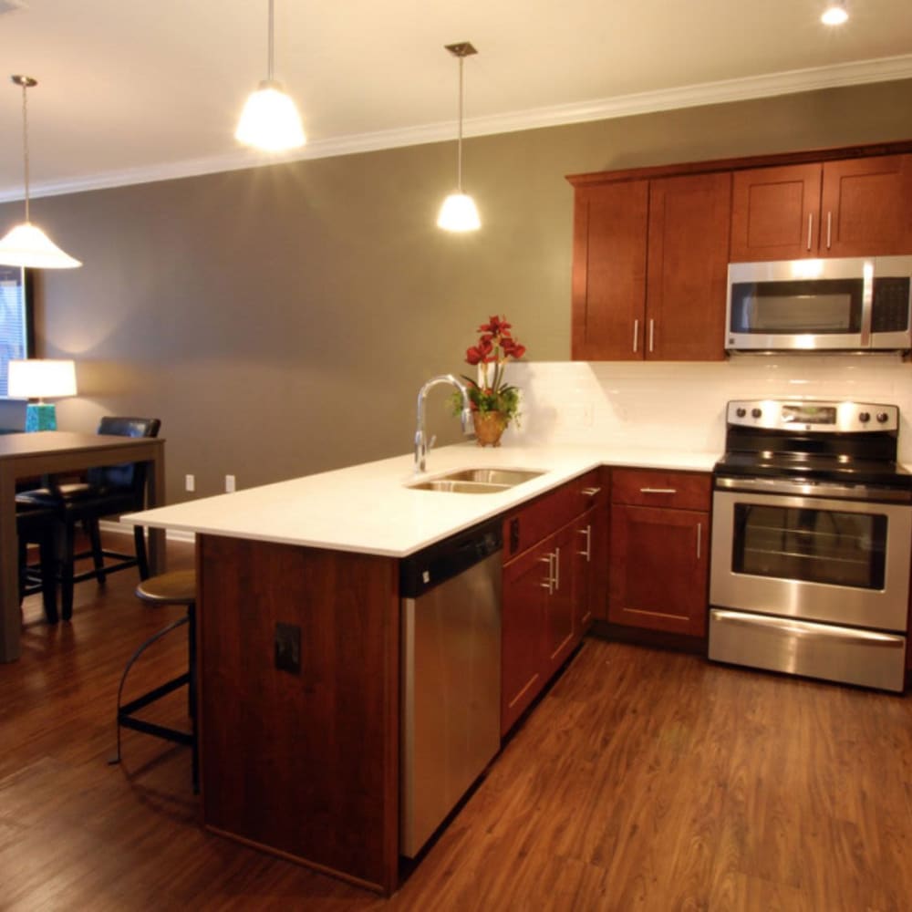 Kitchen with modern amenities and appliances at Oaks Centropolis Apartments in Kansas City, Missouri