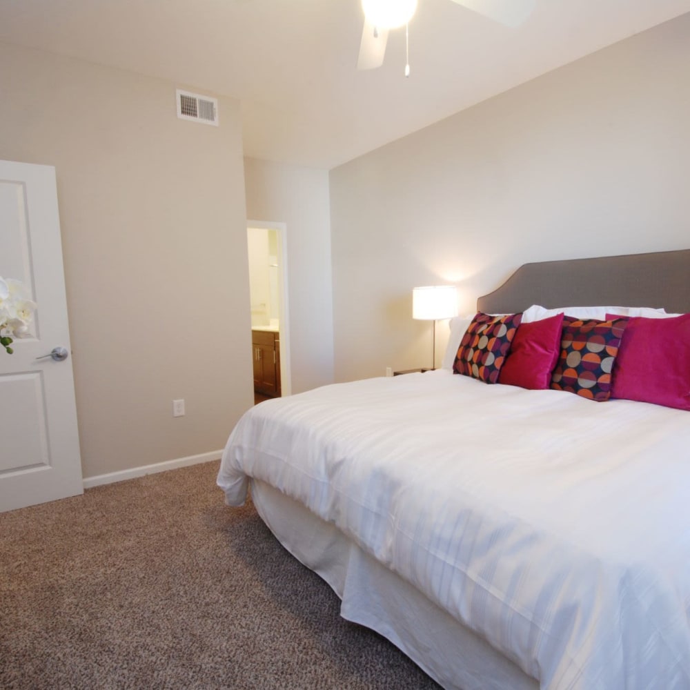 Bedroom with soft carpet at Oaks Centropolis Apartments in Kansas City, Missouri