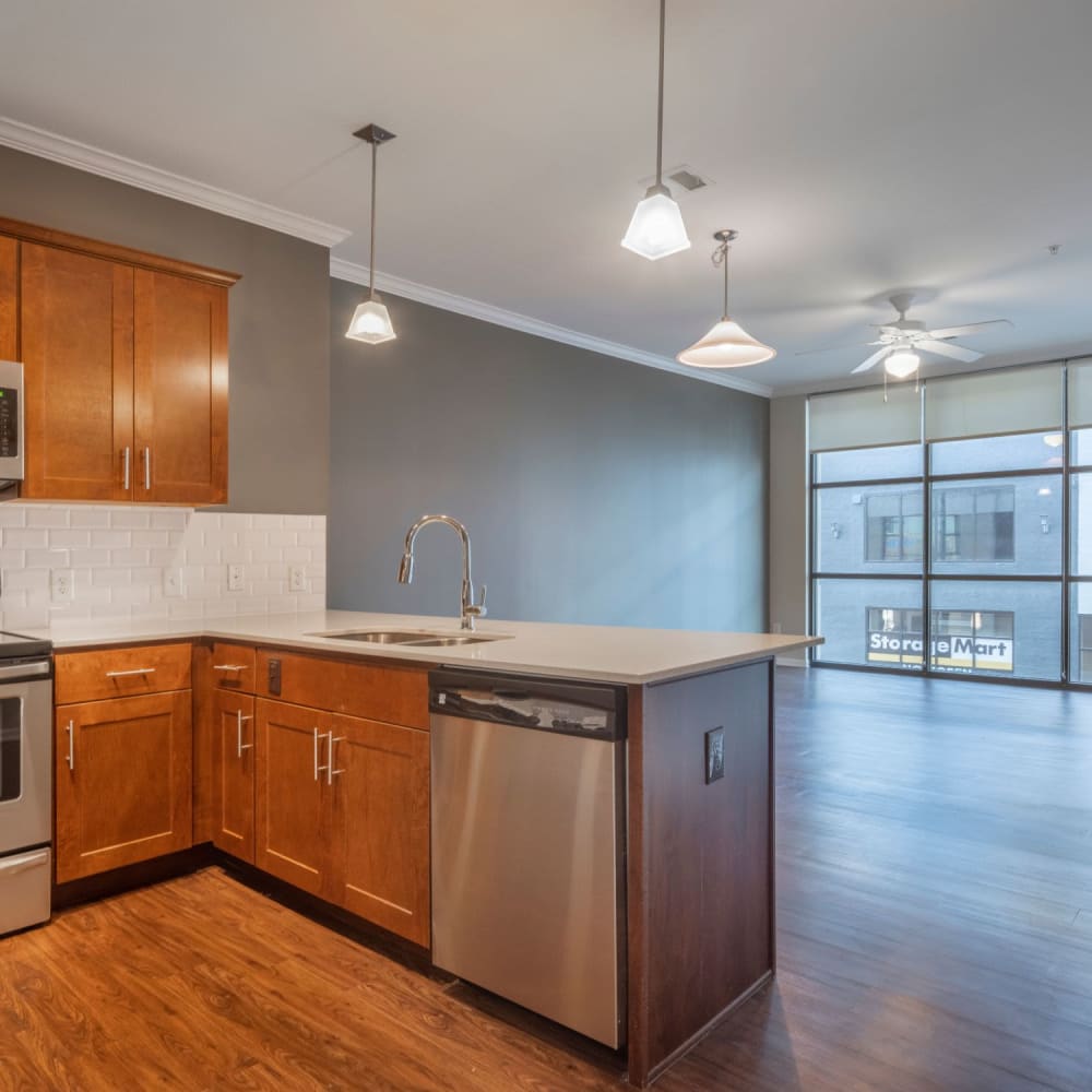 Kitchen with modern appliances and an open floor plan at Oaks Centropolis Apartments in Kansas City, Missouri
