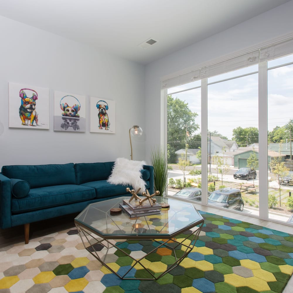 Living room with large windows for natural light at Pinnex in Indianapolis, Indiana