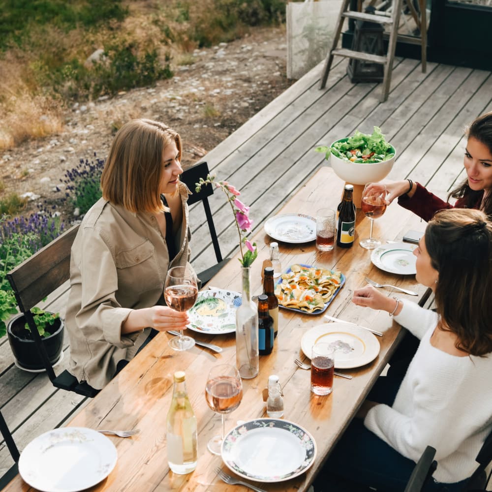 Friends eating at a picnic table at Bellrock La Frontera in Austin, Texas