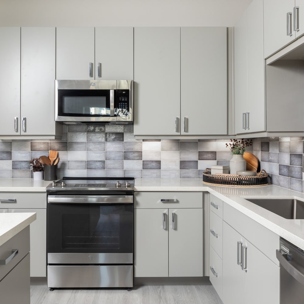 Kitchen rendering with white cabinets and counters at Bellrock La Frontera in Austin, Texas