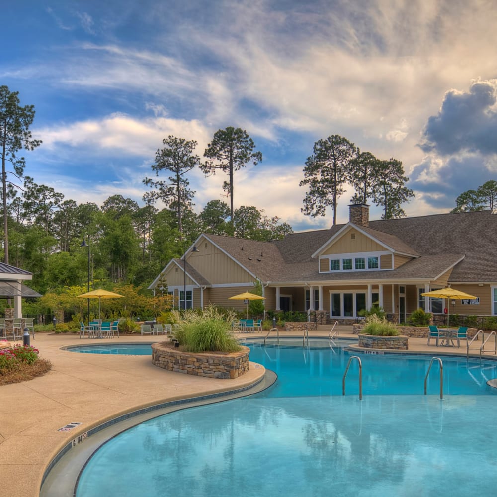 The community swimming pool and exterior of the clubhouse at Lullwater at Blair Stone in Tallahassee, Florida
