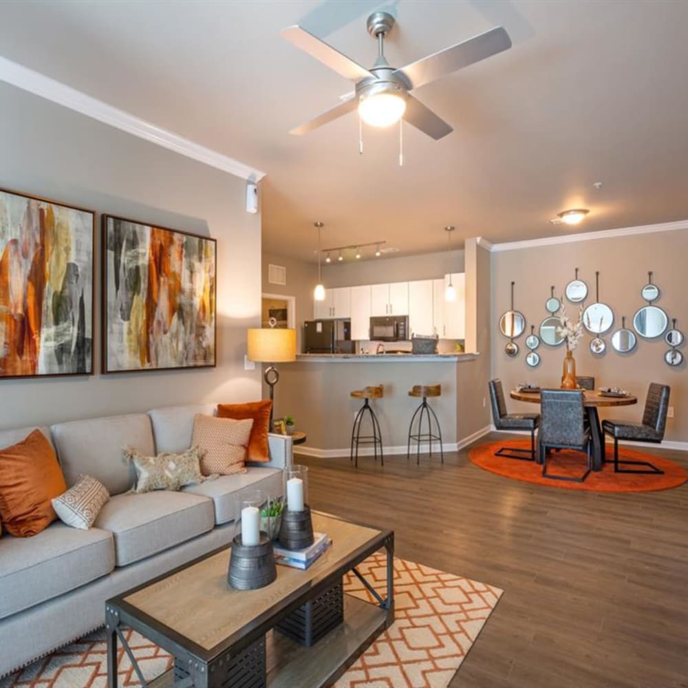 Wood flooring in an apartment living room, dining room and kitchen at Lullwater at Blair Stone in Tallahassee, Florida