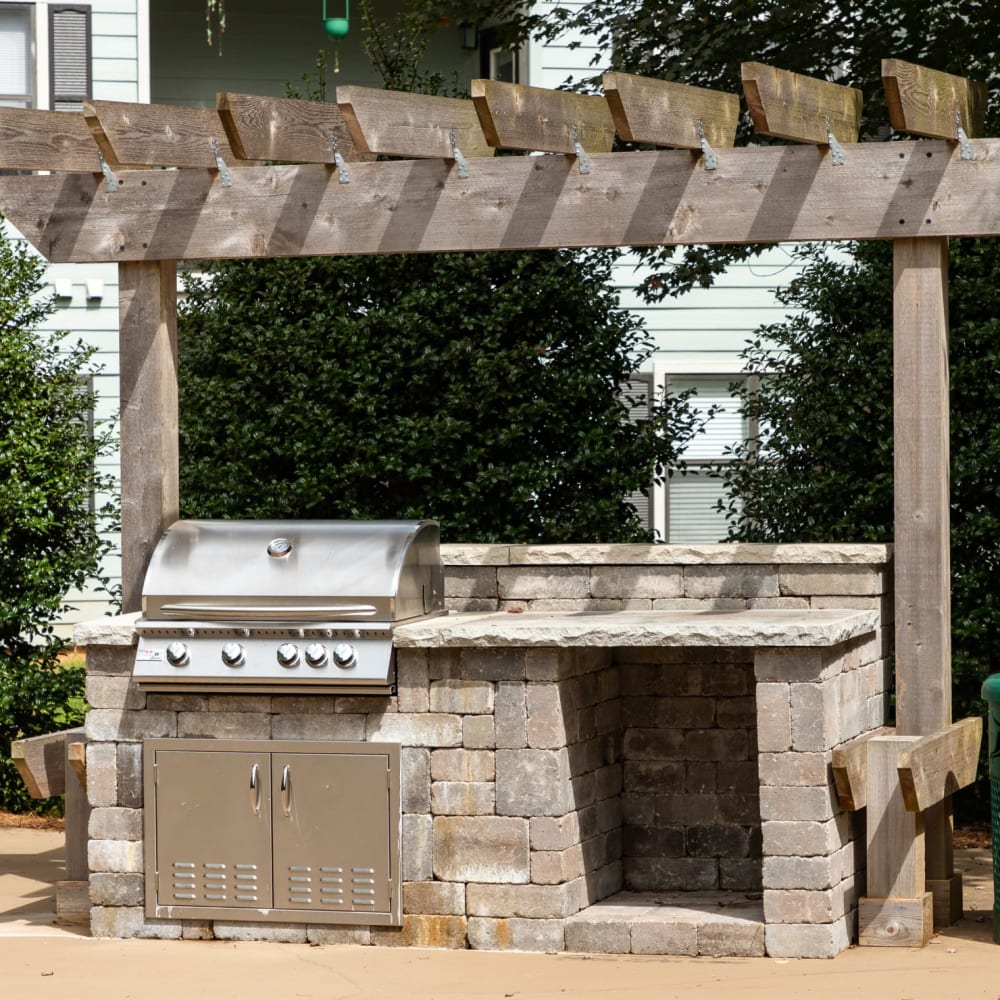 An outdoor grilling station by the community swimming pool at Heritage at Riverstone in Canton, Georgia