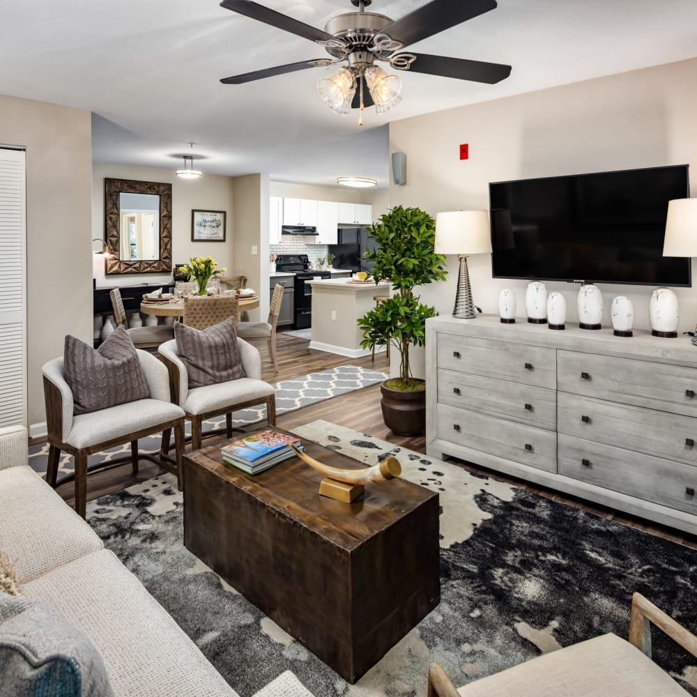 A furnished apartment living room and dining room at Heritage at Riverstone in Canton, Georgia
