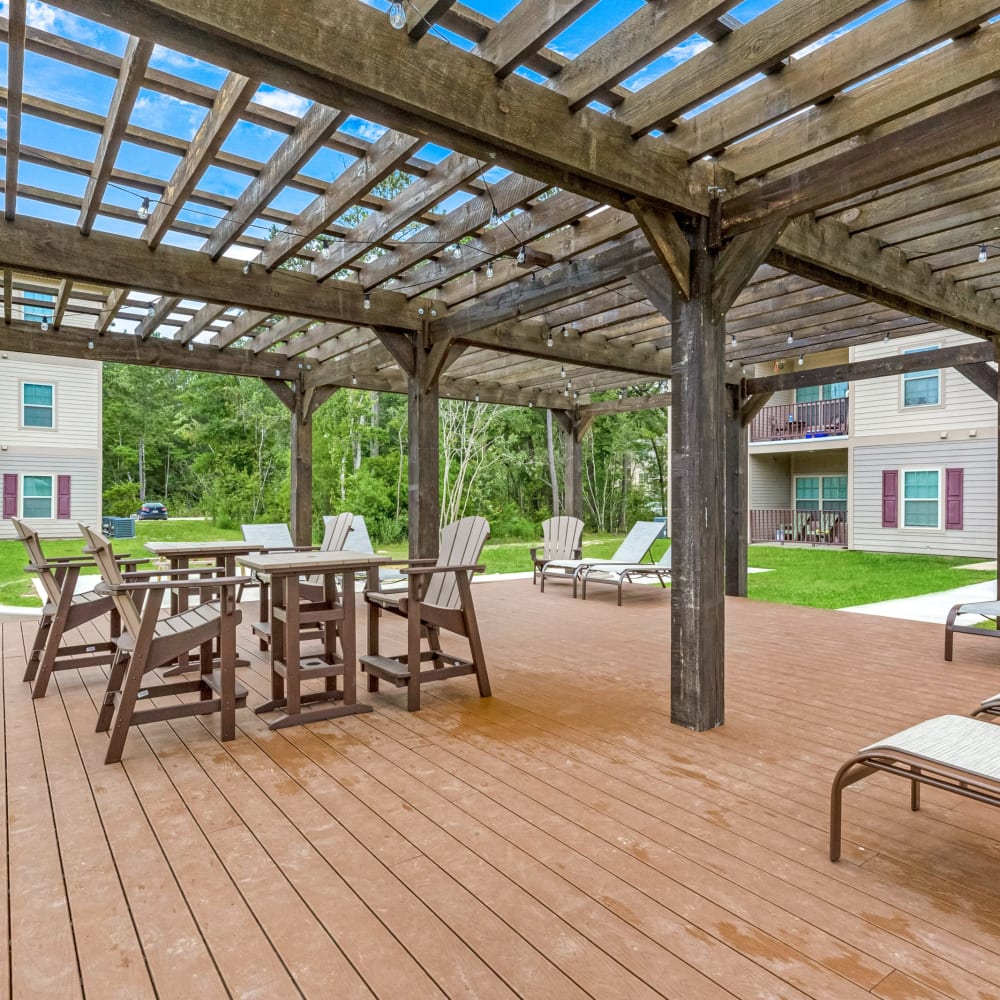 Slightly covered outdoor seating by the swimming pool at Reagan Crossing in Covington, Louisiana