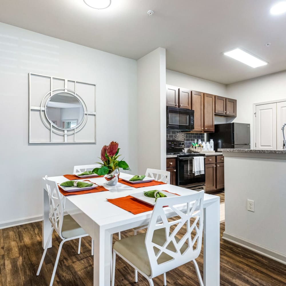 A set dining room table next to the kitchen at Reagan Crossing in Covington, Louisiana