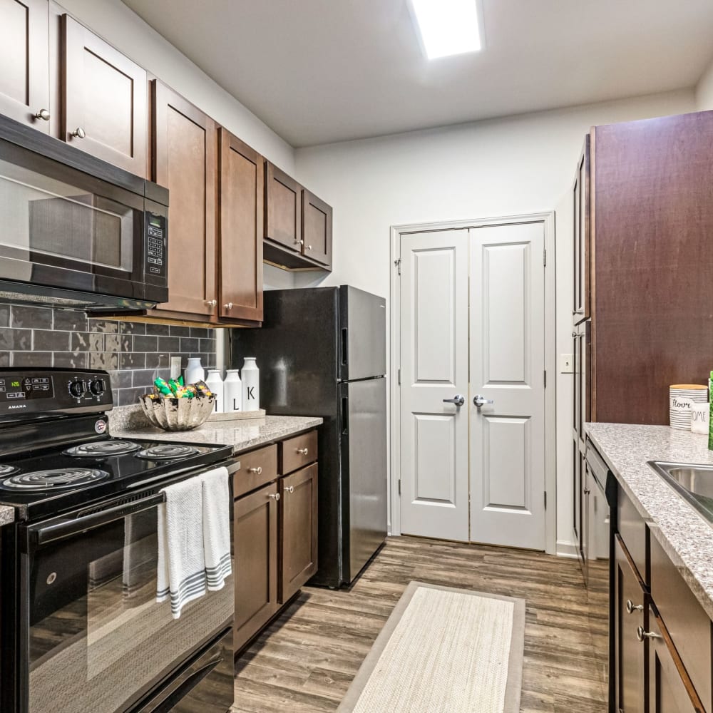 Black appliances in an apartment kitchen at Reagan Crossing in Covington, Louisiana