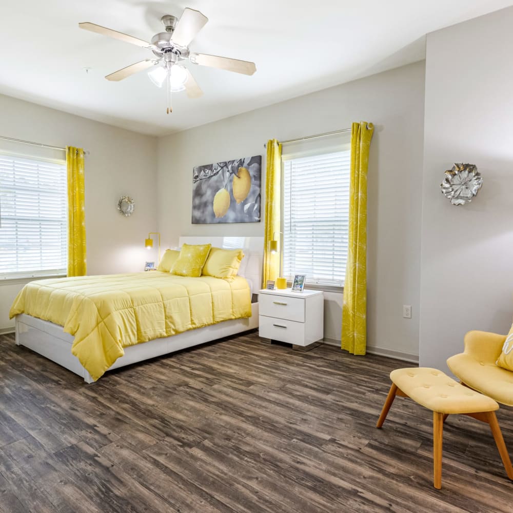 Wood flooring in a spacious, furnished apartment bedroom at Reagan Crossing in Covington, Louisiana