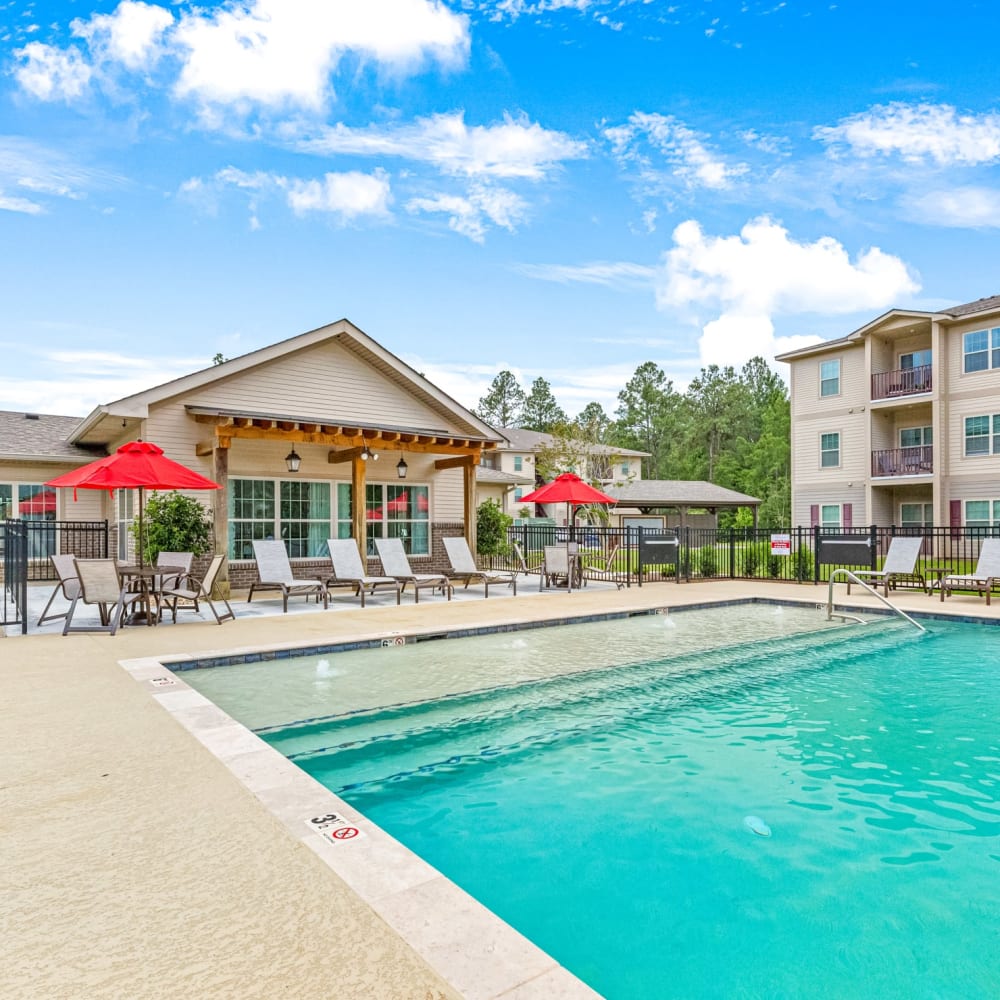 Exterior of the clubhouse and the community swimming pool at Reagan Crossing in Covington, Louisiana