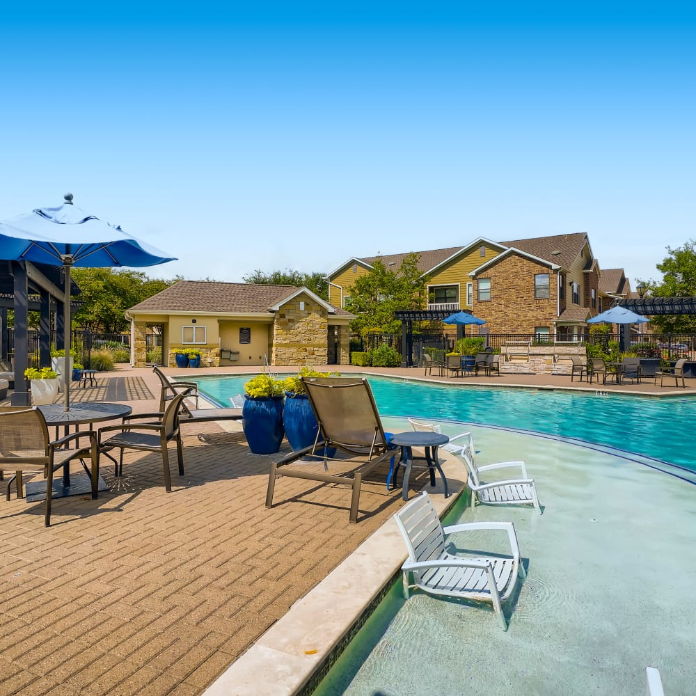 Swimming pool and outdoor recreation area at Grand Villas Apartments in Katy, Texas