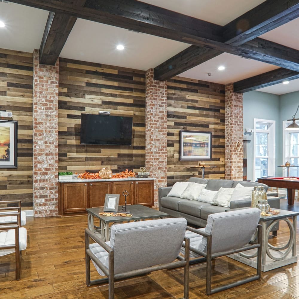 Trendy clubhouse with wood flooring at La Maison Of Saraland, Saraland, Alabama