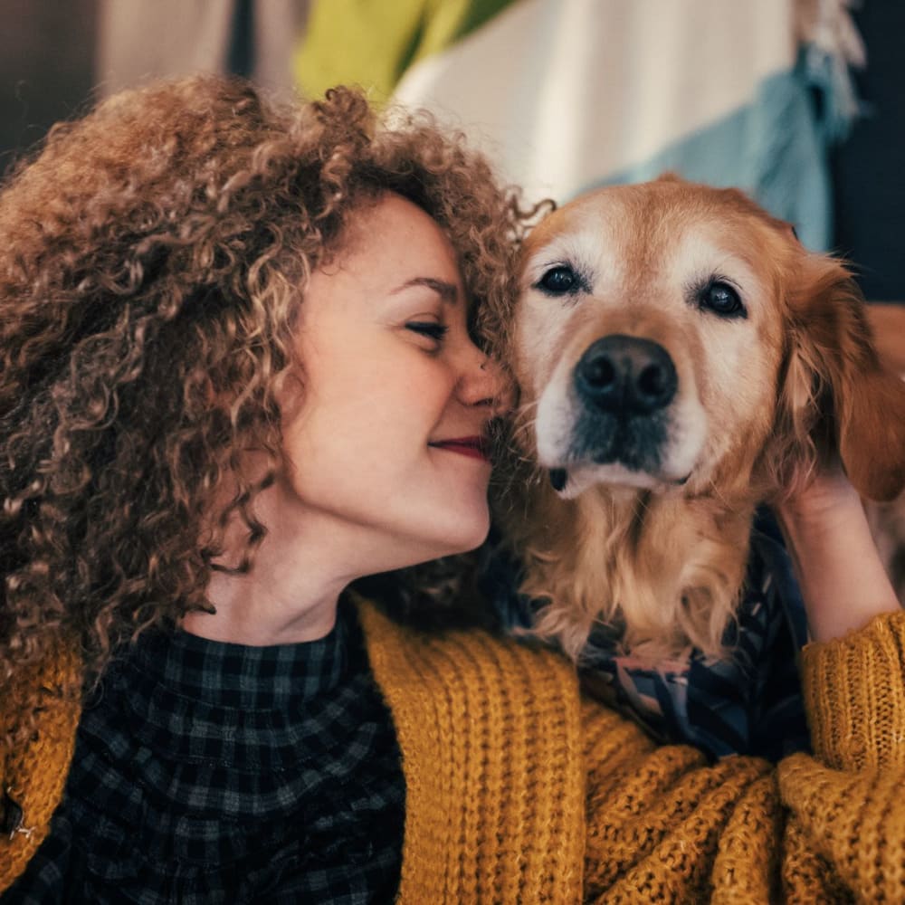 Resident and her puppy relaxing in their new apartment at Center West Apartments in Midlothian, Virginia