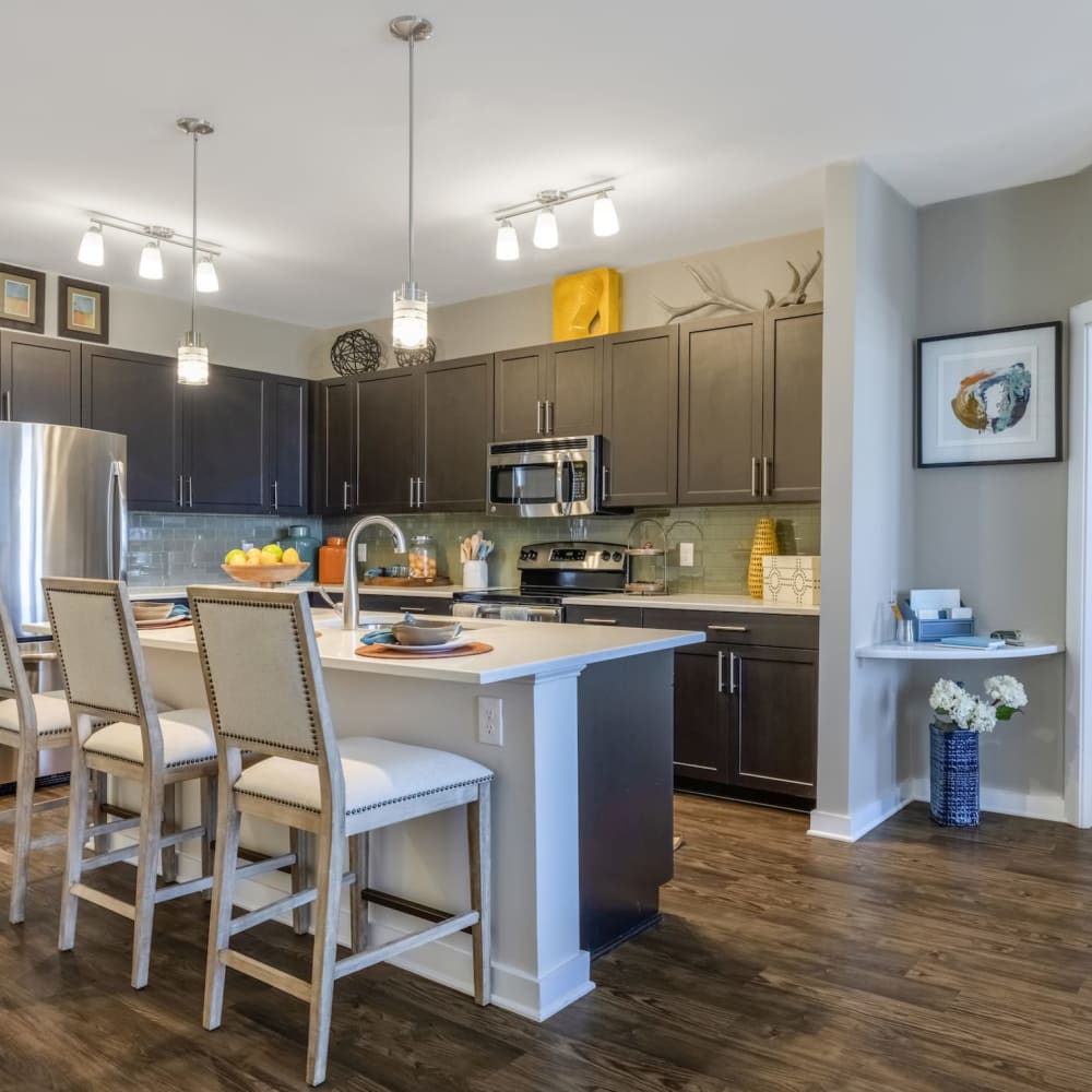 Wood flooring and in island with bar seating in an apartment kitchen at Liberty Mill in Germantown, Maryland