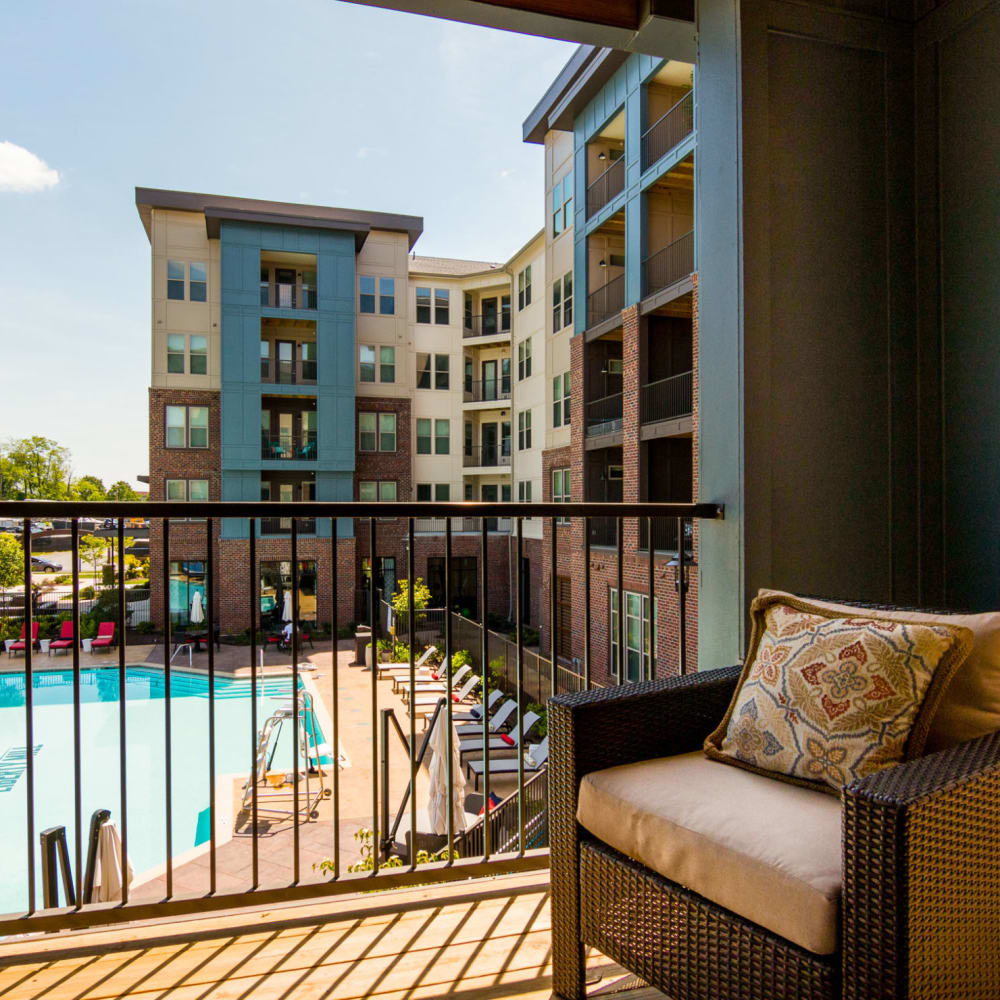 Seating on an apartment patio with a view of the pool at Liberty Mill in Germantown, Maryland