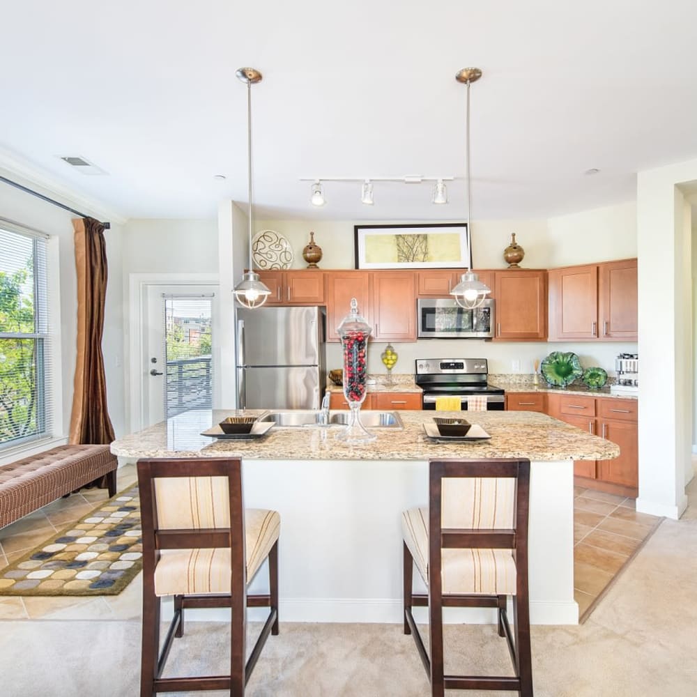 An apartment kitchen with an island at Mode at Hyattsville in Hyattsville, Maryland