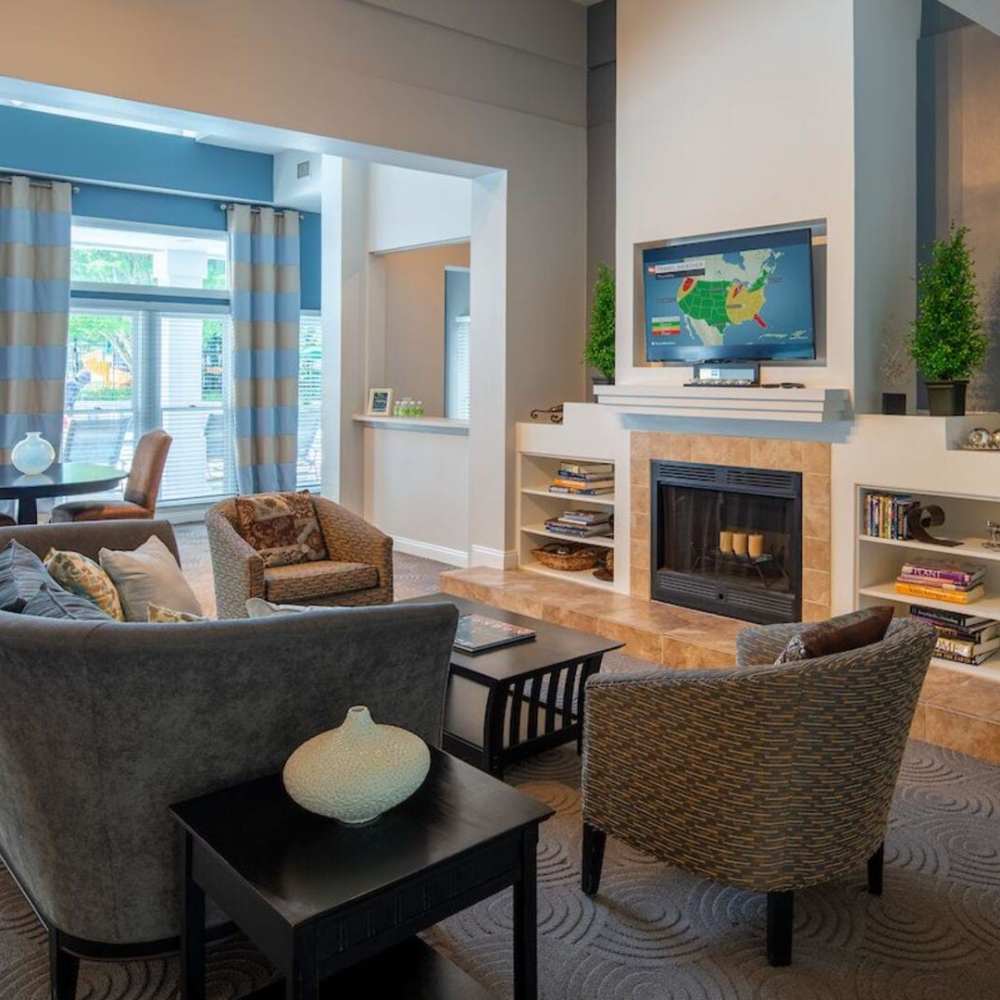 Community room with couch and fireplace at The Elms at Kendall Ridge in Columbia, Maryland