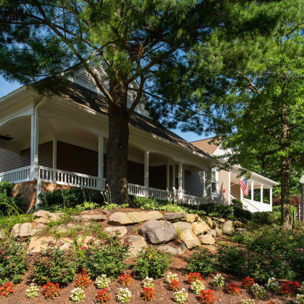 Exterior side view of the building with trees at The Elms at Oakton in Fairfax, Virginia