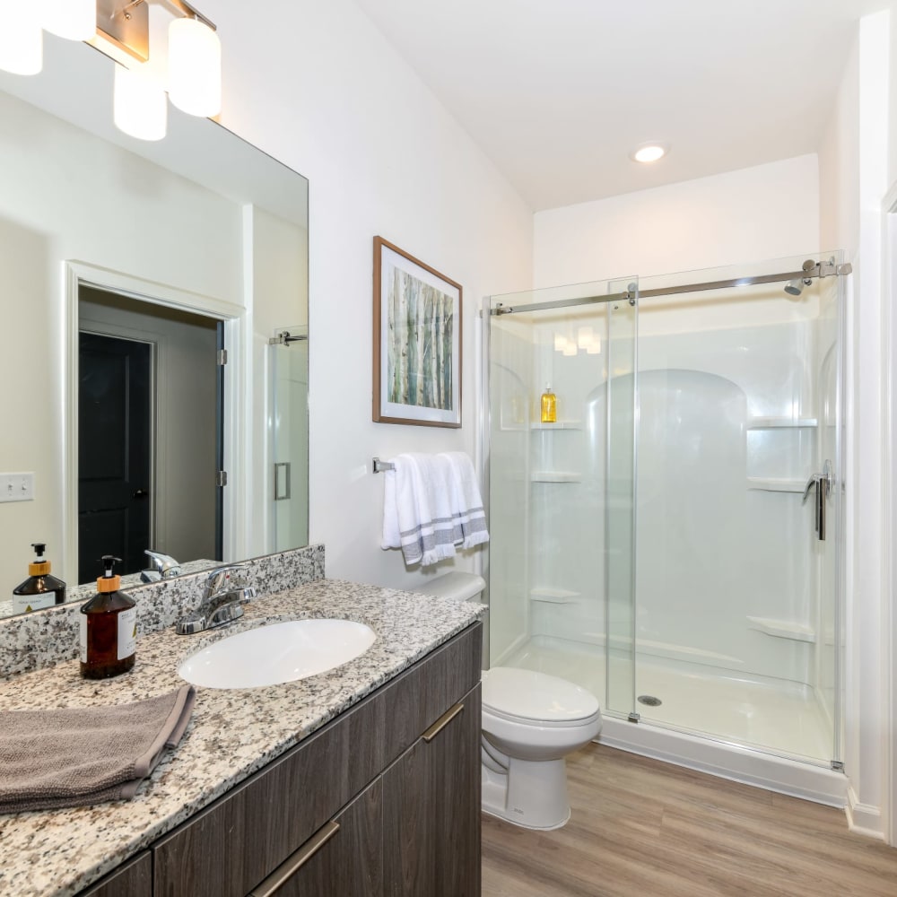 Glass doors on a shower in an apartment bathroom at The Station at Brighton in Grovetown, Georgia