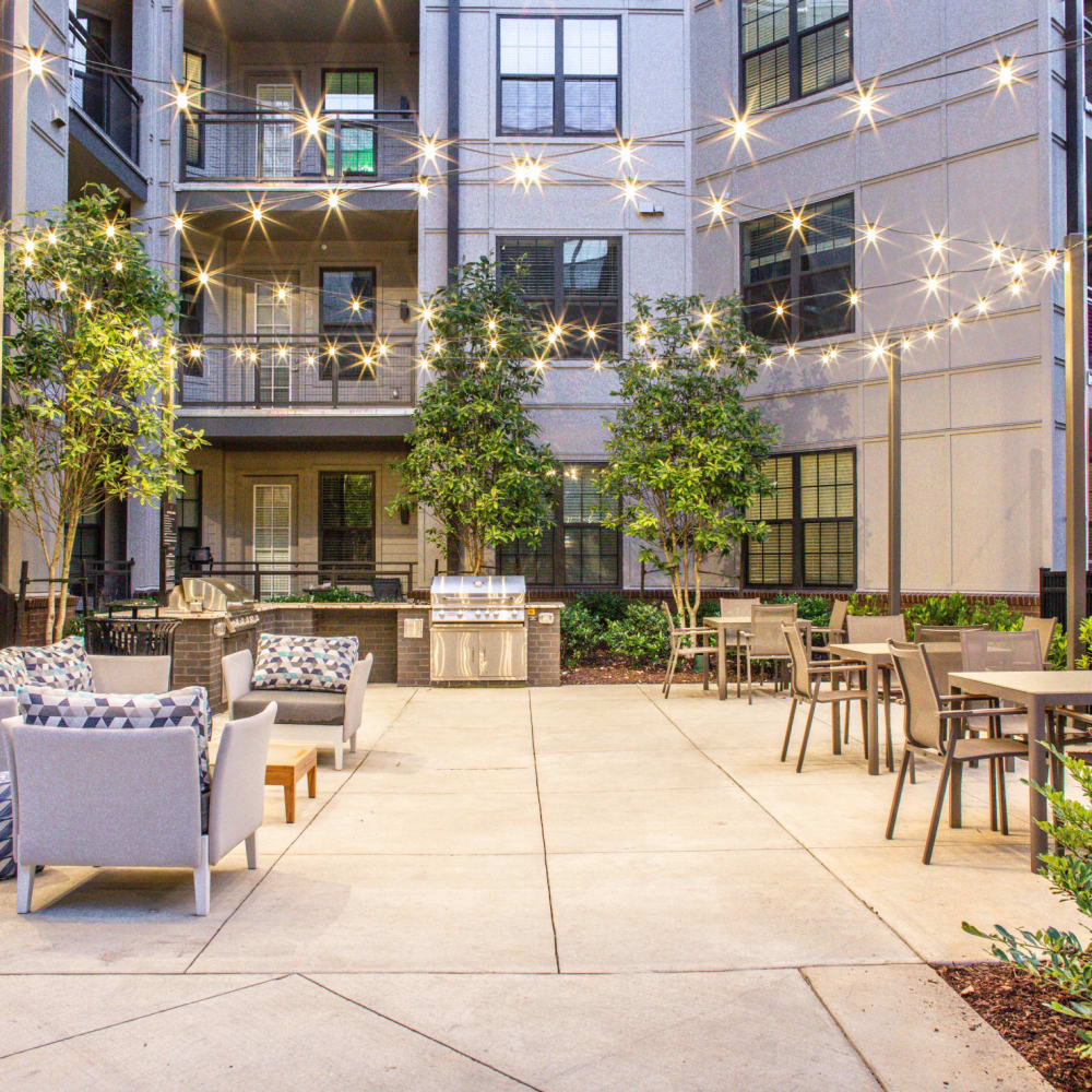 String lights above the outdoor grilling area with seating at Foundry Yards in Birmingham, Alabama