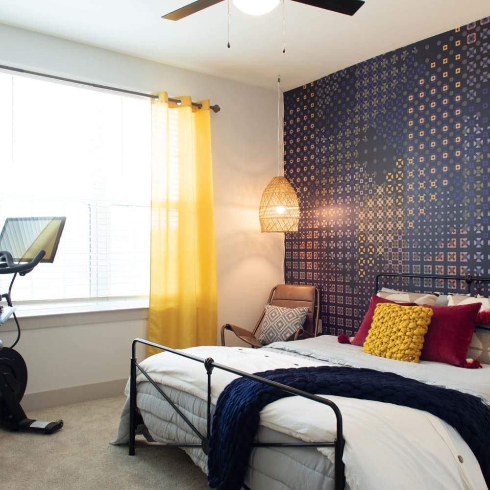 A furnished apartment bedroom with a painted wall at Foundry Yards in Birmingham, Alabama