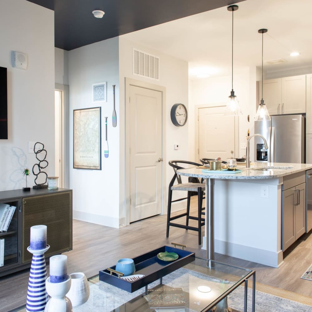 A furnished apartment living room and kitchen island at Foundry Yards in Birmingham, Alabama